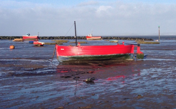 Red boat on Morecambe beach Lancashire