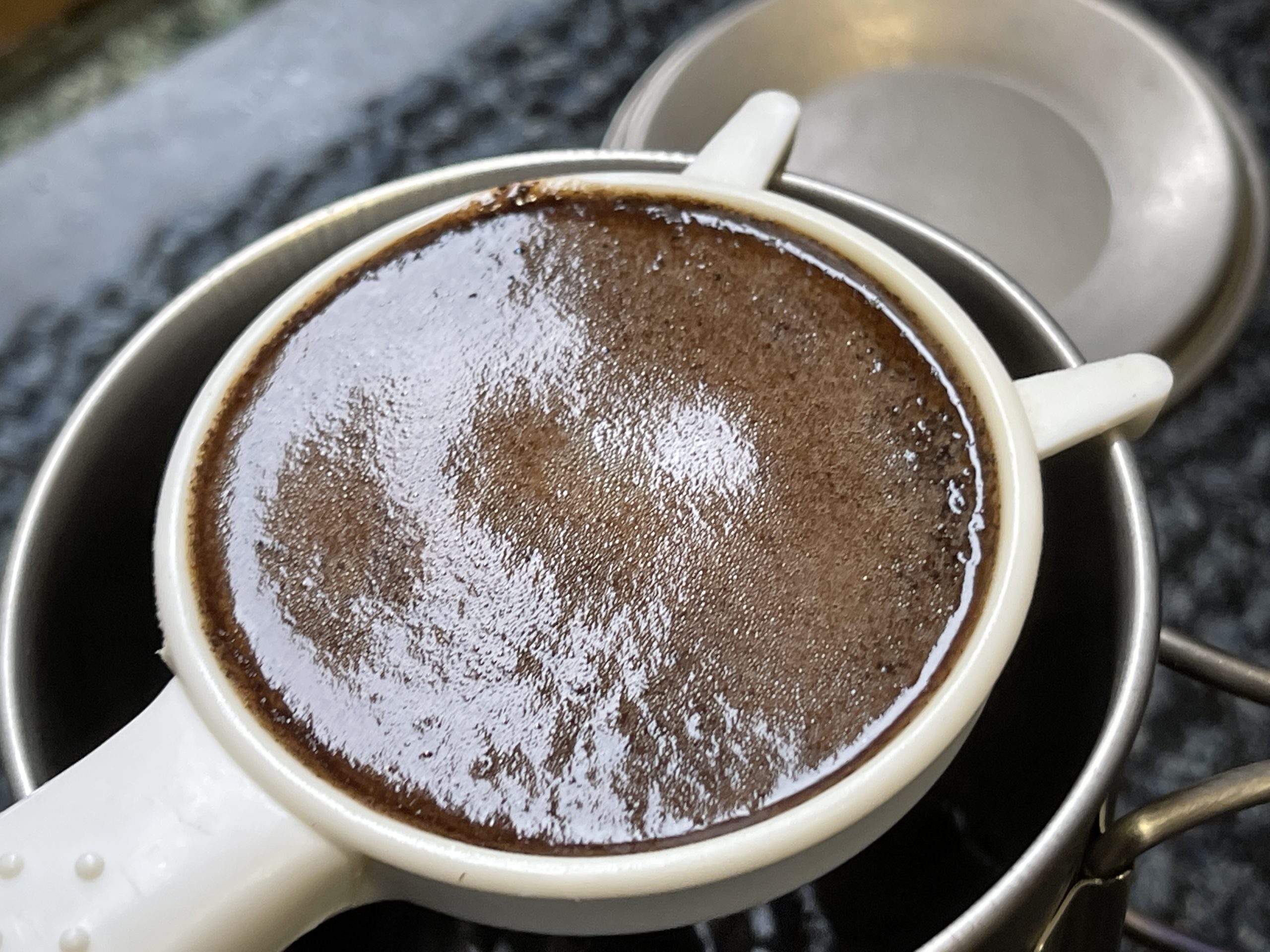 Coffee for camping in a small strainer coffee making gadget