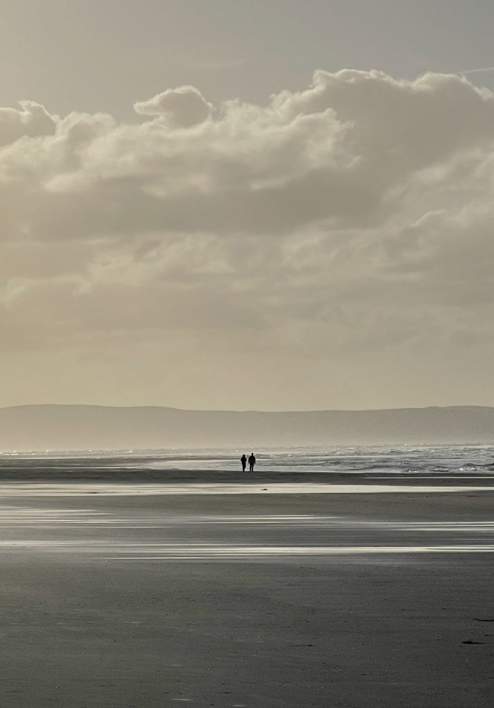 Two people on a misty beach