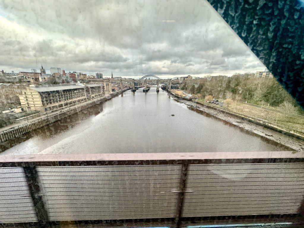 Gateshead Millennium Bridge through a dirty Metro train window