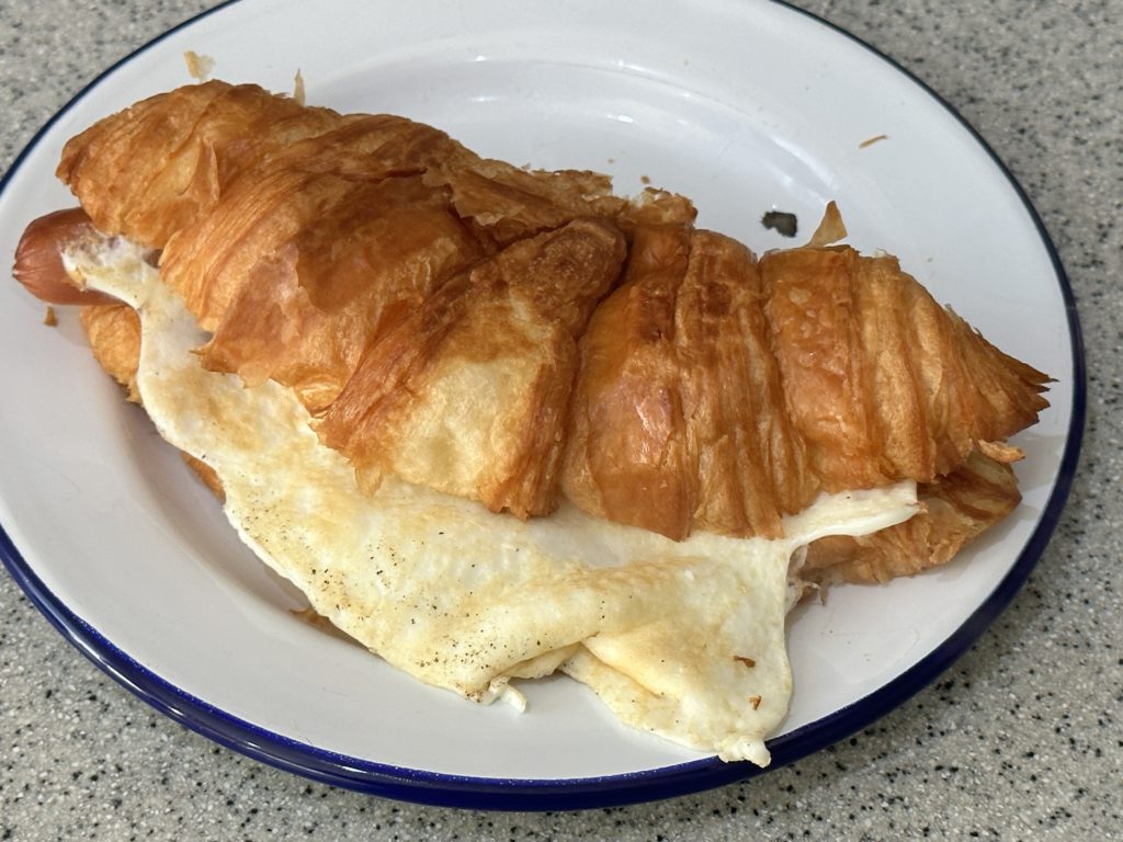 Hot dog and fried egg croissant