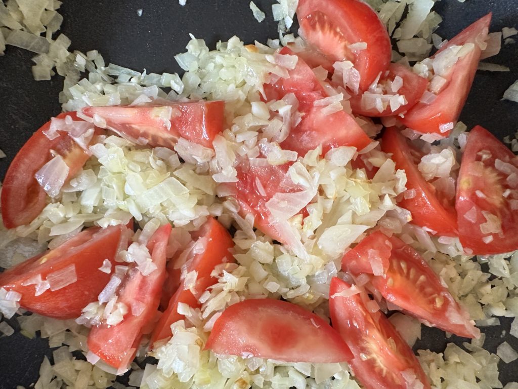 Tomatoes and onions in a pan