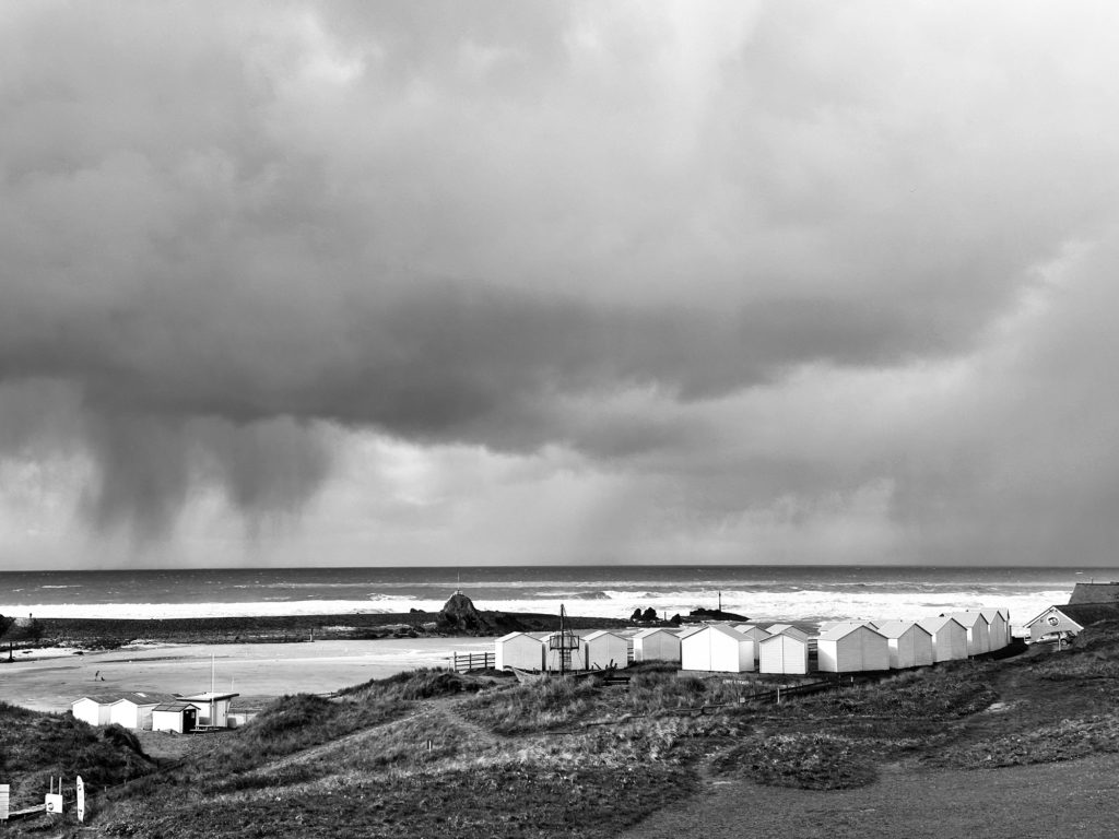 Bude beach huts and rain clouds