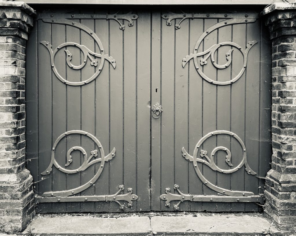 Wooden doors with ornate iron hinges